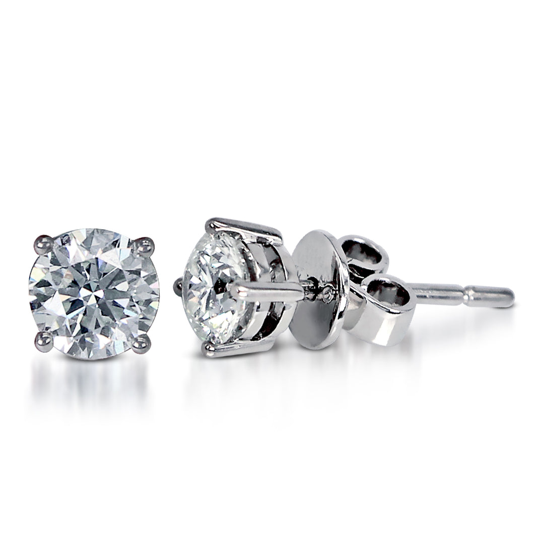 The Solitaire Round Brilliant Stud Earrings is crafted in 14K White Gold and each piece features a single round brilliant diamond --one piece (5.5x5.5x3.6mm) in the clarity grading VS1 with the color J; and the other (5.5x5.6x3.6 mm) in the clarity grading VVS2 with the color J. The total carat weight of both is 1.4-ctw. Inclusive of My Diamond Jewelry Box and Jewelry Certificate 